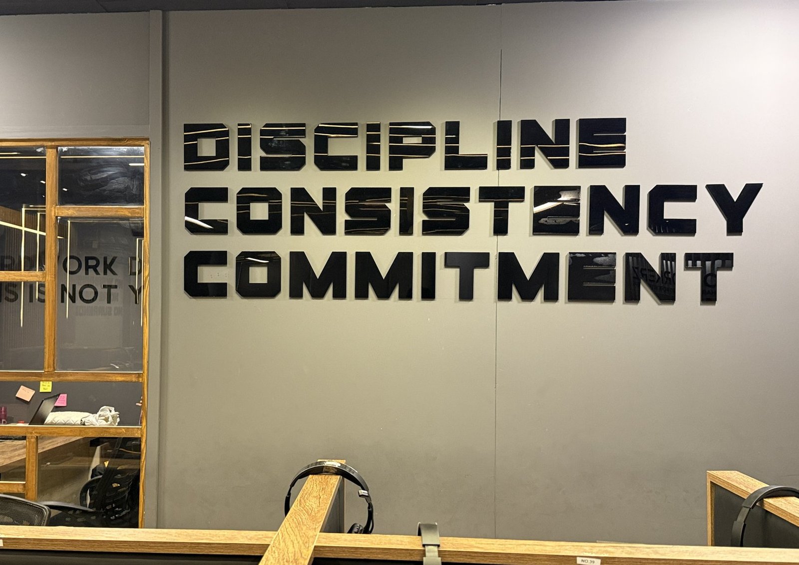 Discipline, Consistency, Commitment installed on the wall at Workerz